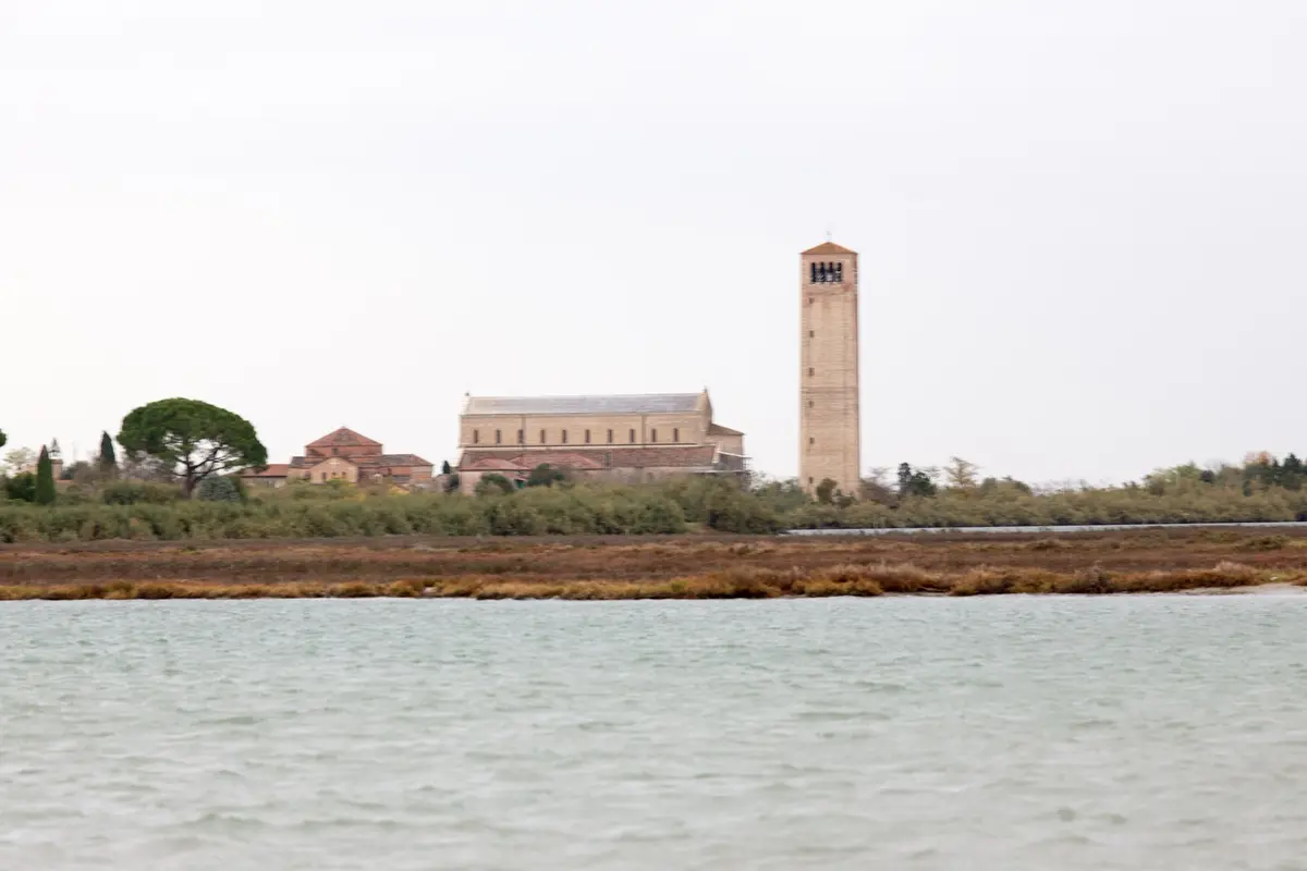 Torcello and its basilica bell tower from the lagoon